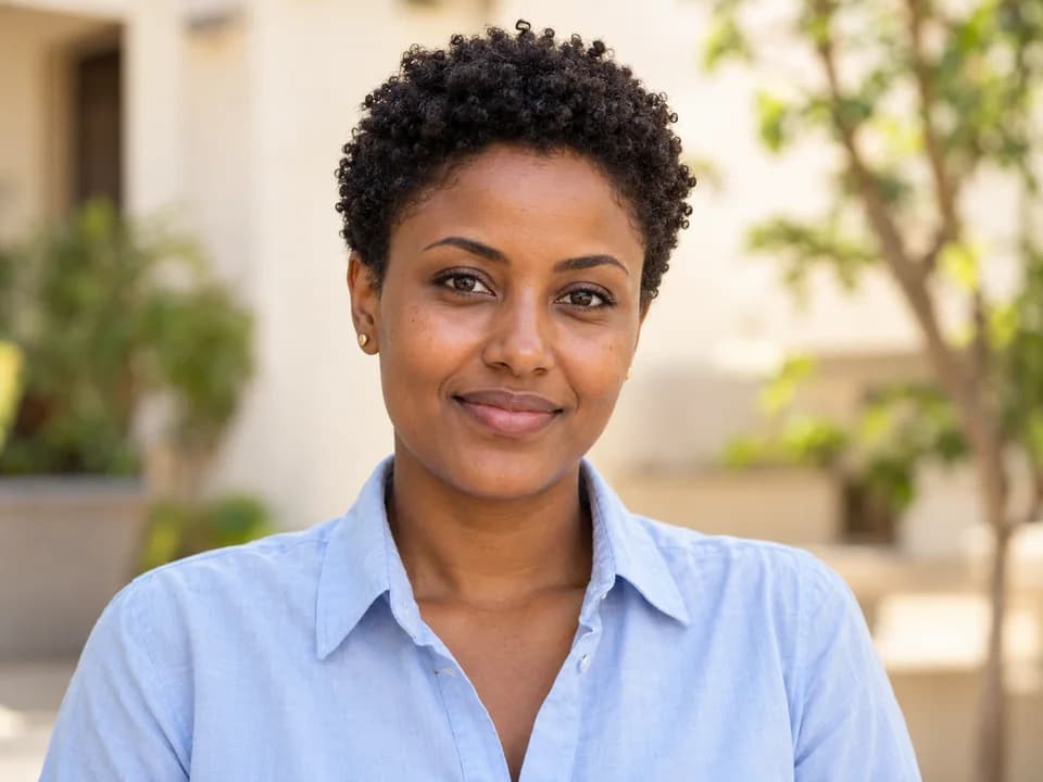 AI-generated illustrative portrait of a woman with short natural coils; not a photograph of Sara T.